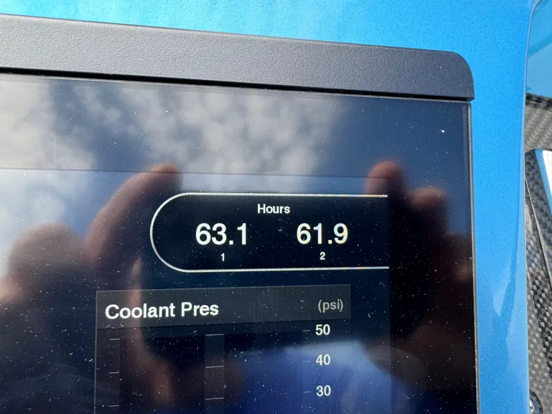 Slide: The Image of Display screen showing engine hours and coolant pressure on a 2011 Cigarette 50 boat. - 5
