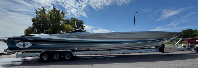 Slide: The Image of 2011 Cigarette 50 boat on trailer under blue sky. - 6