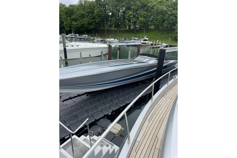 Slide: The Image of 2011 Cigarette 50' Marauder docked at marina with lush green backdrop. - 7