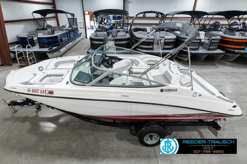 Slide: The Image of 2018 Yamaha SX190 boat in showroom, white with red accents, on trailer. - 1