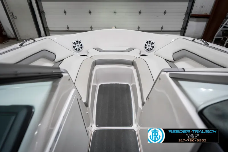 Slide: The Image of 2018 Yamaha Boats SX190 interior with seating and speakers in a garage setting. - 18