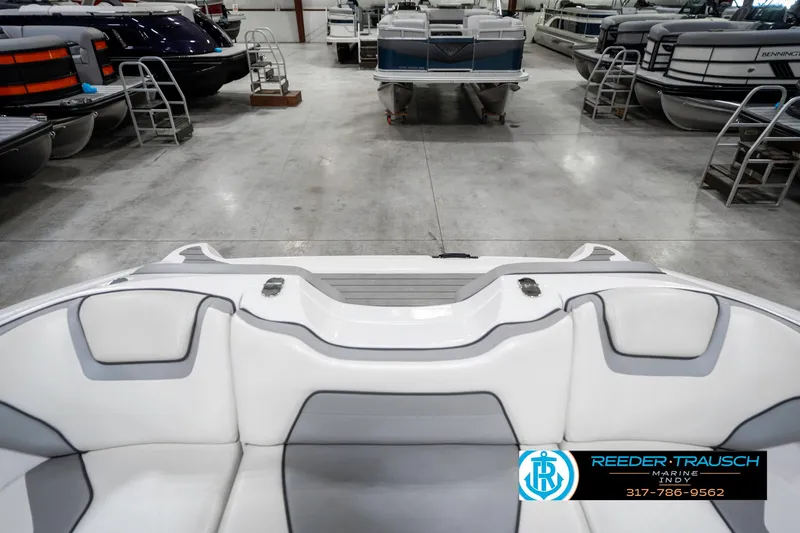 Slide: The Image of 2018 Yamaha Boats SX190 interior in showroom with other boats. - 21