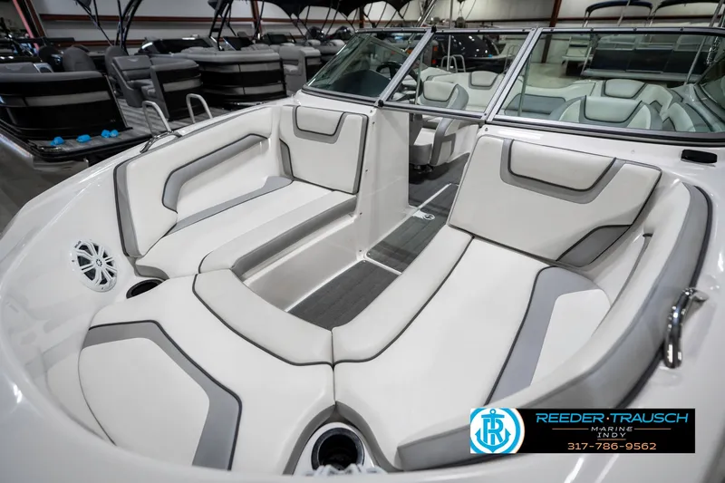 Slide: The Image of 2018 Yamaha Boats SX190 interior with white and gray seating in showroom. - 22