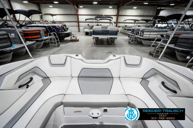 Slide: The Image of 2018 Yamaha Boats SX190 interior in showroom with multiple boats displayed. - 30