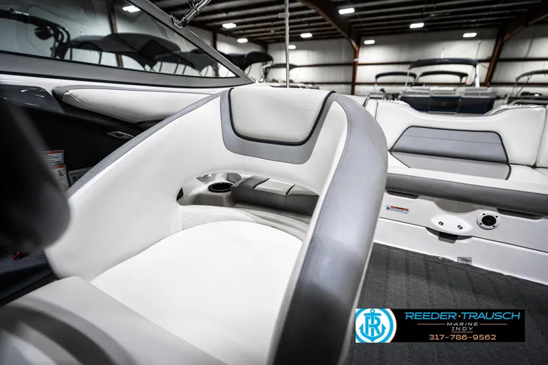 Slide: The Image of 2018 Yamaha Boats SX190 interior with white and gray seating in a showroom. - 38