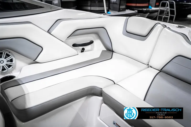 Slide: The Image of 2018 Yamaha SX190 boat interior with white and gray seating, featuring sleek design and speaker system. - 39