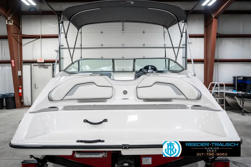Slide: The Image of 2018 Yamaha Boats SX190 in a showroom, featuring sleek design and comfortable seating. - 9