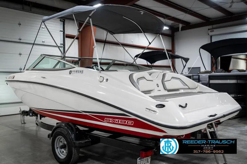 Slide: The Image of 2018 Yamaha SX190 boat in showroom, featuring sleek design and red accents. - 10