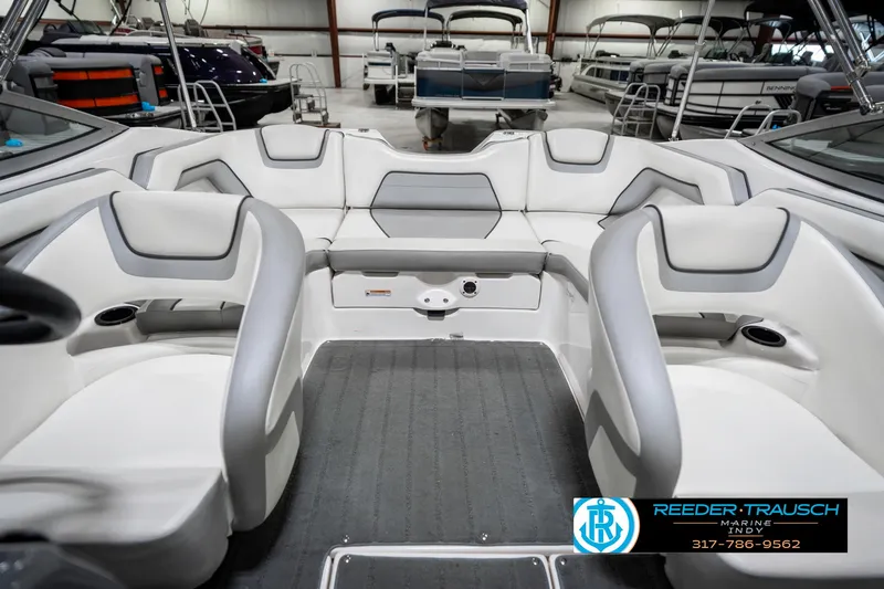 Slide: The Image of 2018 Yamaha SX190 boat interior with white and gray seating in showroom. - 20