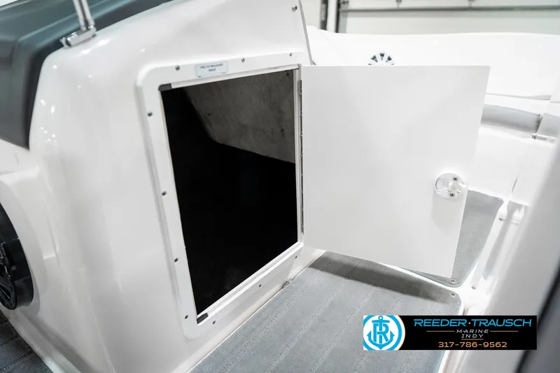 Slide: The Image of 2018 Yamaha SX190 boat storage compartment with open door, showcasing interior space. - 25