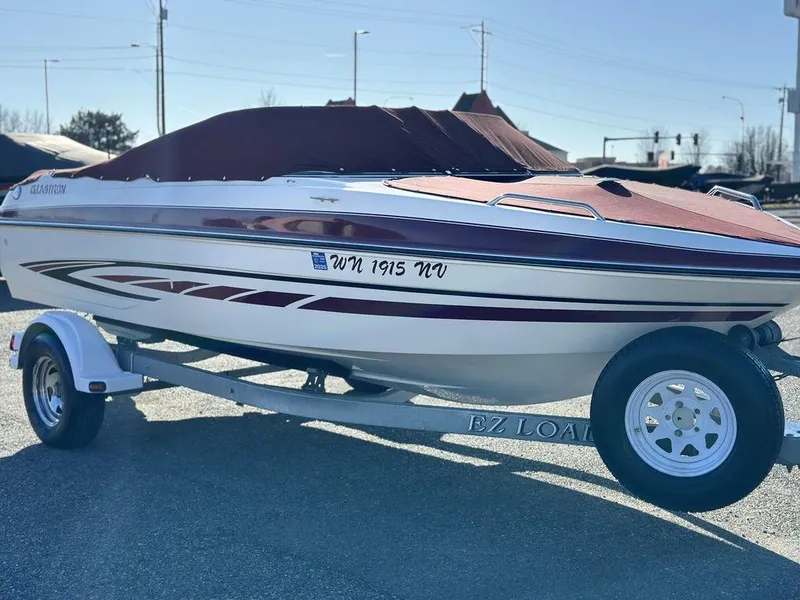 Slide: The Image of 2007 Glastron GT 185 boat on trailer with cover, parked outdoors. - 16