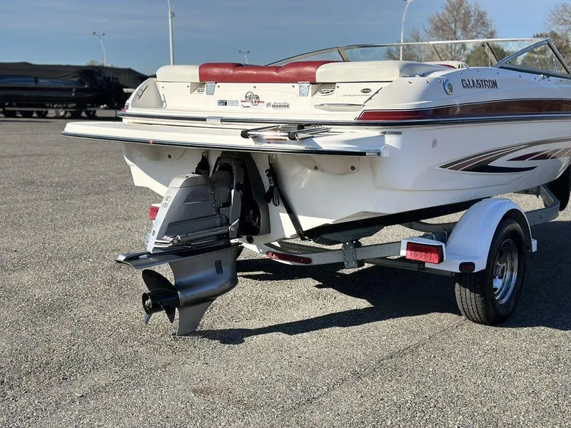 Slide: The Image of 2007 Glastron GT 185 boat on trailer, rear view showing outboard motor and sleek design. - 3