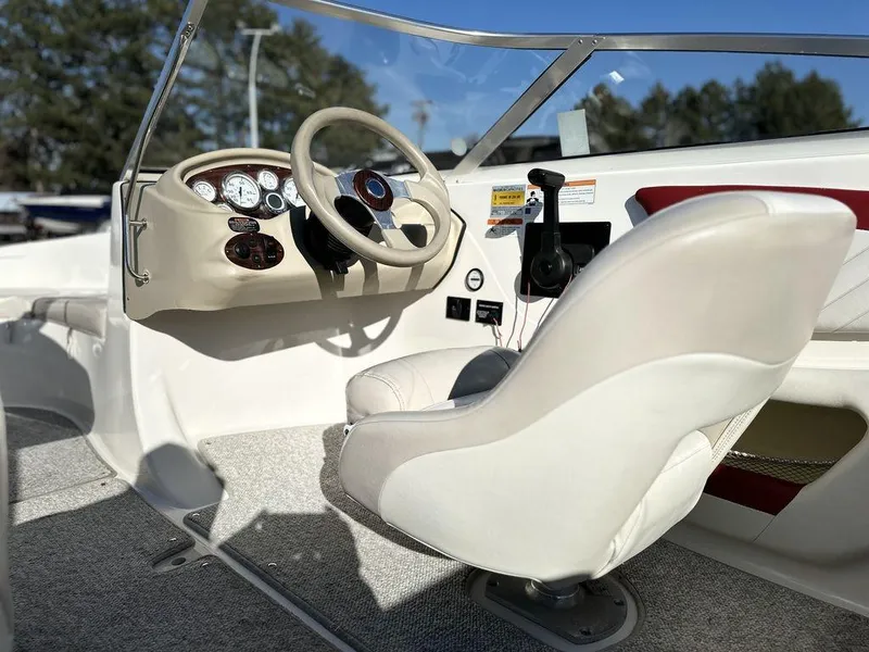 Slide: The Image of 2007 Glastron GT 185 boat interior with steering wheel and captain's chair. - 6