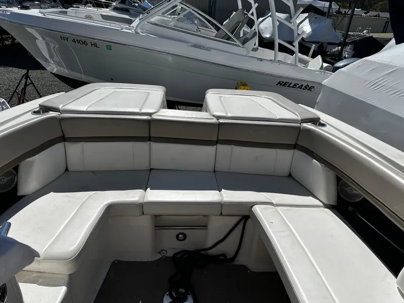 Slide: The Image of 2013 Sea Ray 270 SLX boat interior with white cushioned seating. - 13