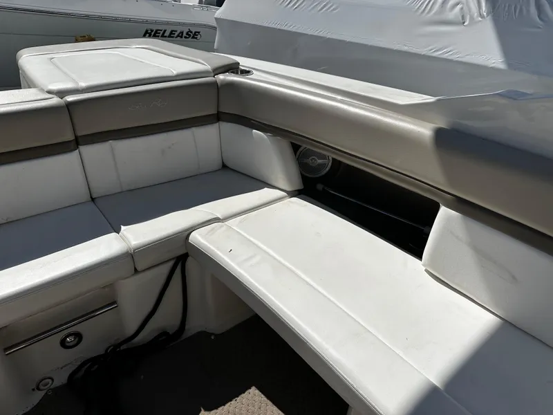 Slide: The Image of Interior seating of a 2013 Sea Ray 270 SLX boat, featuring white and beige upholstery. - 15