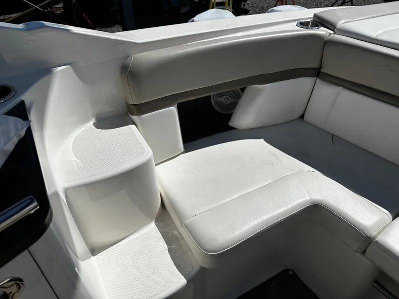 Slide: The Image of Interior seating of a 2013 Sea Ray 270 SLX boat, featuring white and beige upholstery. - 16