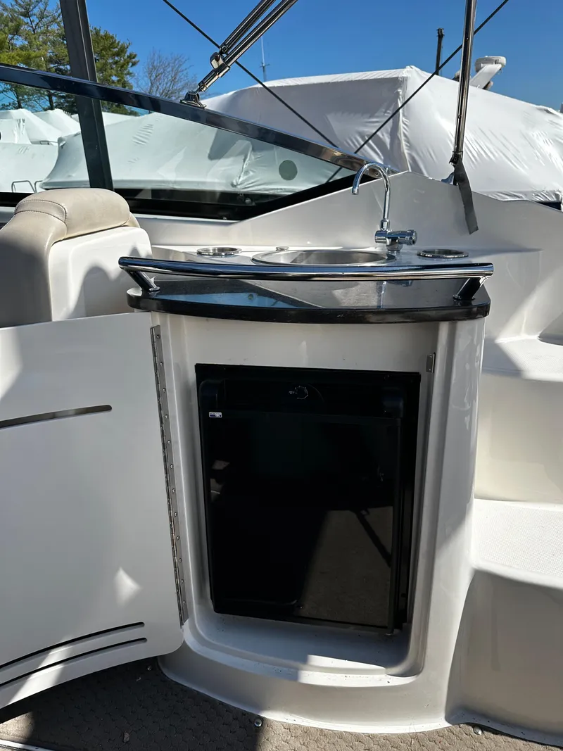 Slide: The Image of 2013 Sea Ray 270 SLX boat interior with sink and mini fridge. - 20