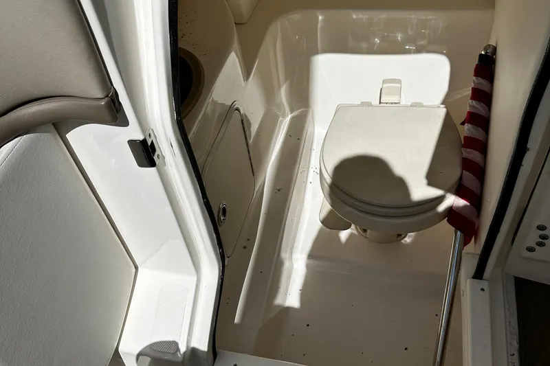 Slide: The Image of 2013 Sea Ray 270 SLX boat interior with compact marine toilet. - 21