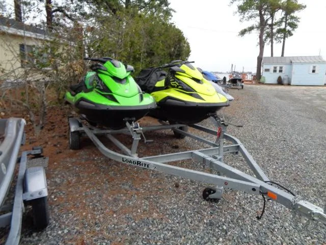 Slide: The Image of Two Yamaha WaveRunner VX Cruiser HO jet skis on a Load Rite trailer, parked on gravel. - 18