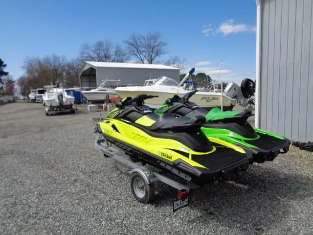 Slide: The Image of 2021 Yamaha WaveRunner VX Cruiser HO jet skis on a trailer in a boatyard. - 4