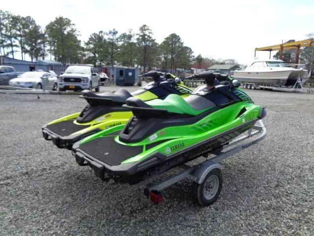 Slide: The Image of 2021 Yamaha WaveRunner VX Cruiser HO jet skis on a trailer in a parking lot. - 6