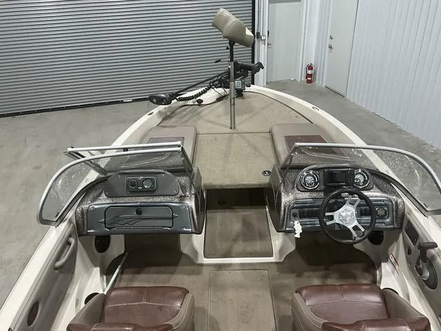 Slide: The Image of 2009 Ranger Reata 186 boat interior with dual consoles and steering wheel in a garage. - 10