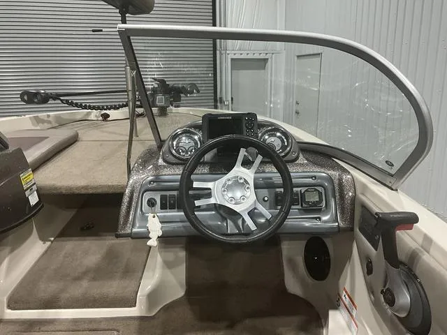 Slide: The Image of 2009 Ranger Reata 186 boat dashboard with steering wheel and control panel. - 12