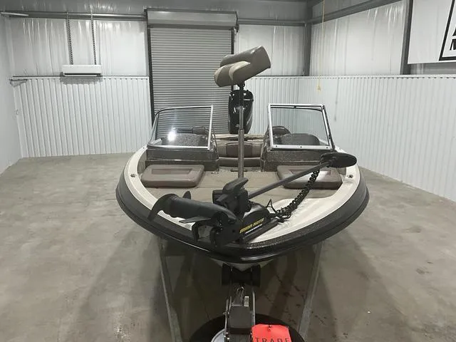 Slide: The Image of 2009 Ranger Reata 186 boat in storage, featuring dual windshields and a trolling motor. - 7