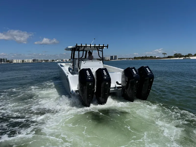 Slide: The Image of 2025 Invincible 40 Catamaran with four powerful engines cruising on open water. - 10