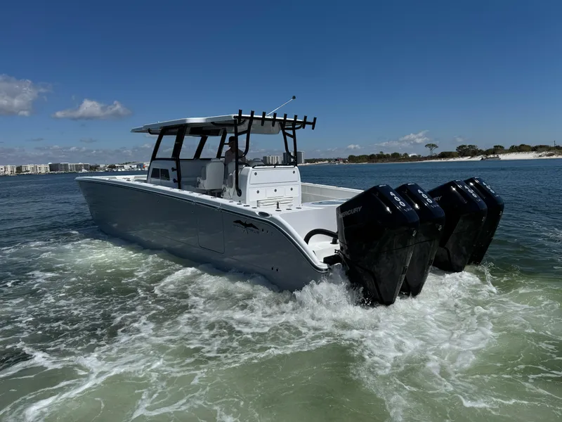 Slide: The Image of 2025 Invincible 40 Catamaran cruising on open water with powerful engines. - 11