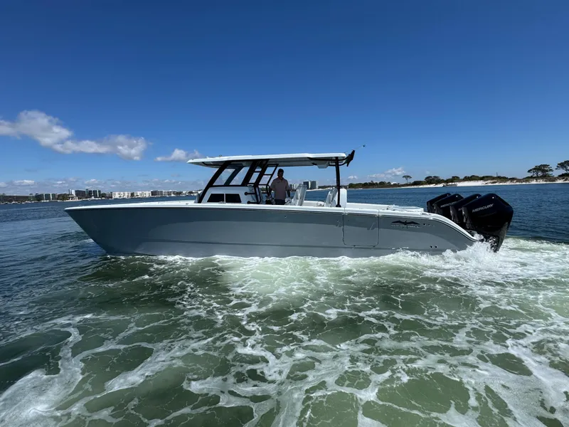 Slide: The Image of 2025 Invincible 40 Catamaran cruising on open water under clear blue skies. - 13