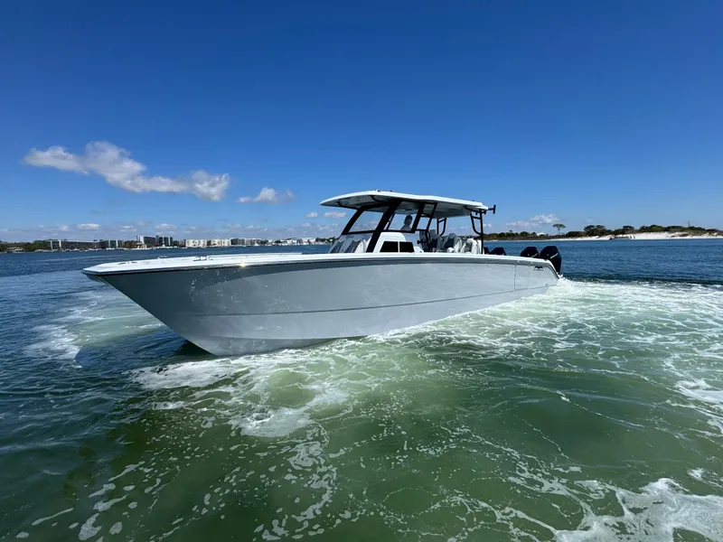 Slide: The Image of 2025 Invincible 40 Catamaran cruising on open water under clear blue skies. - 17