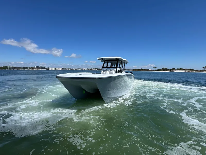 Slide: The Image of 2025 Invincible 40 Catamaran cruising on open water under clear blue skies. - 21