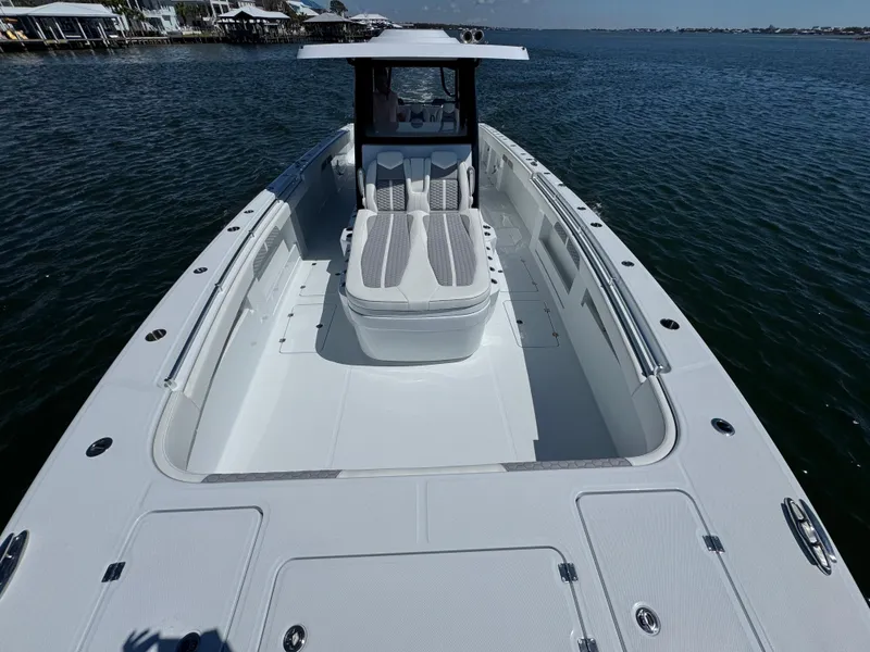 Slide: The Image of 2025 Invincible 40 Catamaran on water, showcasing spacious deck and sleek design. - 23