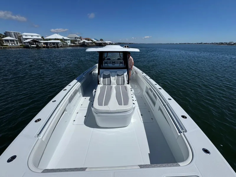 Slide: The Image of 2025 Invincible 40 Catamaran on calm waters, showcasing spacious deck and sleek design. - 24