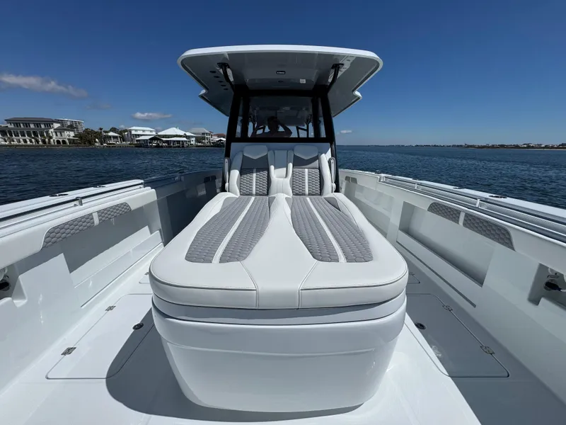 Slide: The Image of 2025 Invincible 40 Catamaran on water, showcasing sleek design and spacious deck. - 25