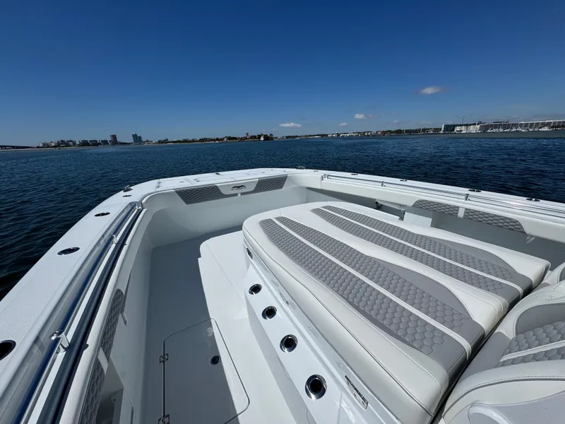 Slide: The Image of 2025 Invincible 40 Catamaran with spacious seating, cruising on calm waters under a clear blue sky. - 26