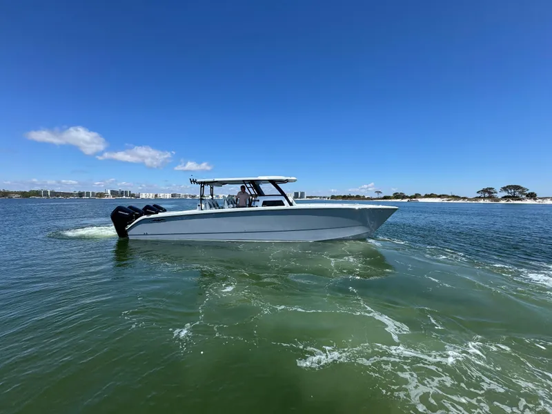 Slide: The Image of 2025 Invincible 40 Catamaran cruising on calm waters under a clear blue sky. - 3