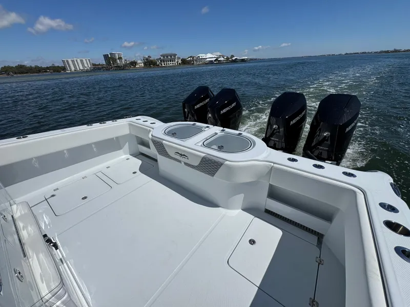 Slide: The Image of 2025 Invincible 40 Catamaran with quad engines cruising on open water. - 37