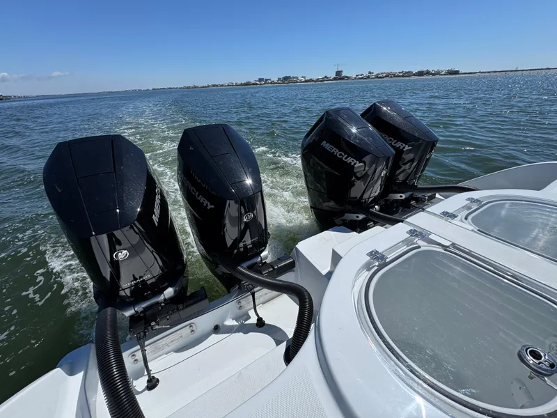 Slide: The Image of 2025 Invincible 40 Catamaran with four powerful Mercury outboard engines on open water. - 42