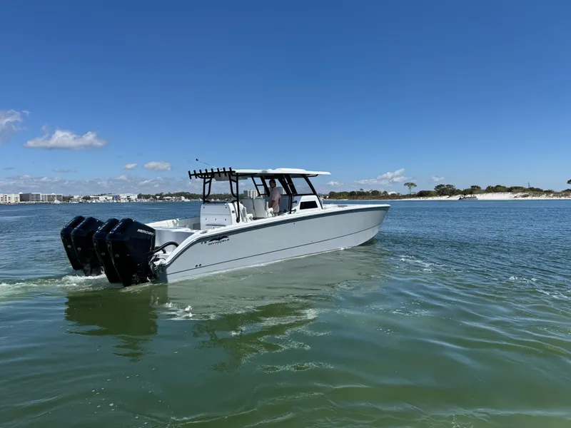 Slide: The Image of 2025 Invincible 40 Catamaran cruising on calm waters under a clear blue sky. - 5