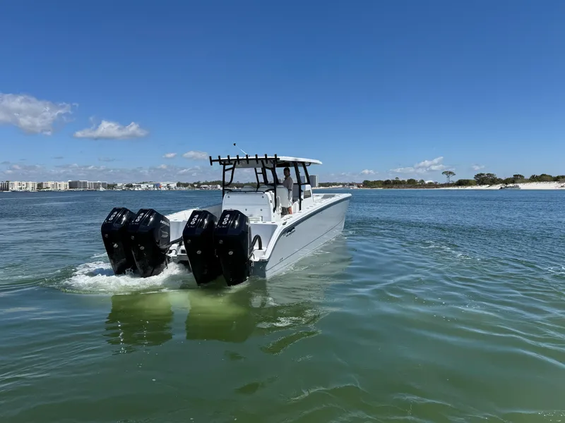 Slide: The Image of 2025 Invincible 40 Catamaran cruising on clear waters under a blue sky. - 6