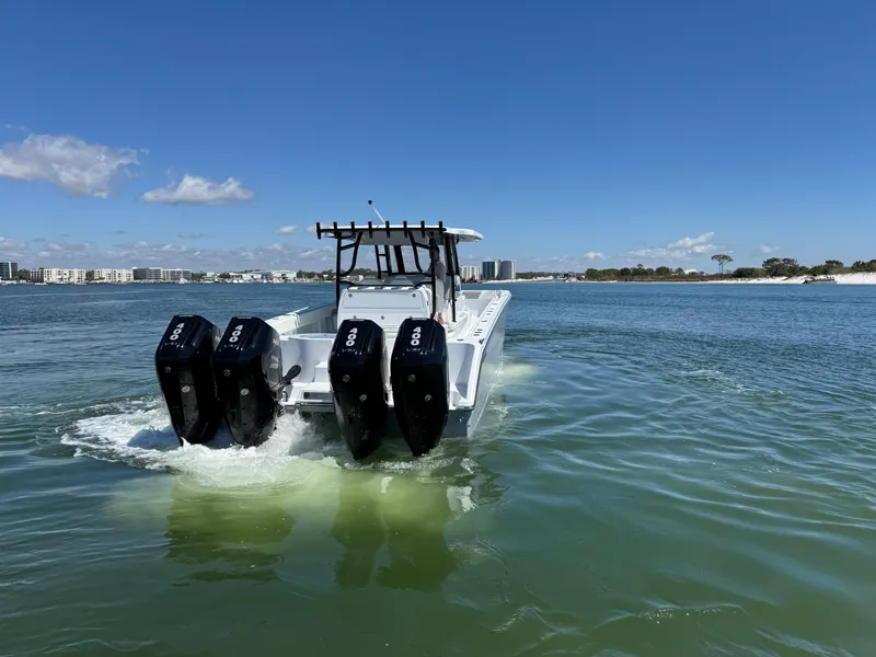 Slide: The Image of 2025 Invincible 40 Catamaran with four engines cruising on a sunny day. - 7