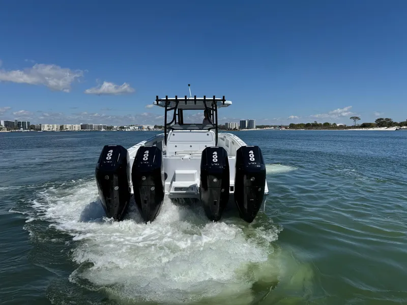 Slide: The Image of 2025 Invincible 40 Catamaran with four engines cruising on a sunny day. - 8