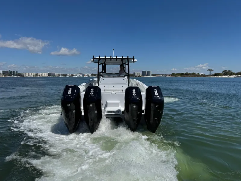 Slide: The Image of 2025 Invincible 40 Catamaran with four engines cruising on a sunny day. - 9