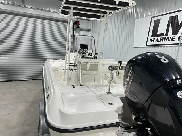 Slide: The Image of 2021 Bayliner T21BAY boat with Mercury engine in a garage setting. - 15