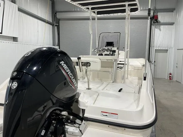 Slide: The Image of 2021 Bayliner T21BAY boat with Mercury engine in a storage facility. - 16