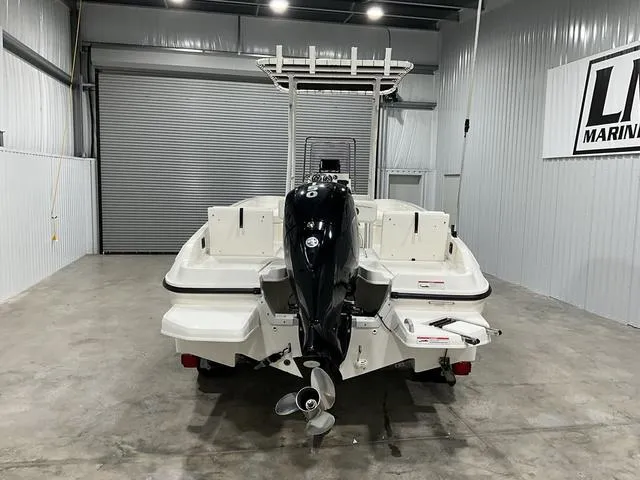 Slide: The Image of 2021 Bayliner T21BAY boat in a garage, rear view with outboard motor. - 6