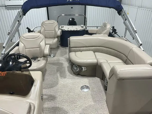 Slide: The Image of 2019 Avalon 22 LSZ pontoon boat interior with beige seating and steering console. - 11