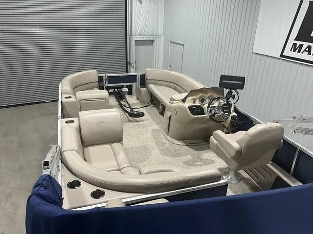 Slide: The Image of 2019 Avalon 22 LSZ pontoon boat interior with beige seating and modern dashboard. - 13